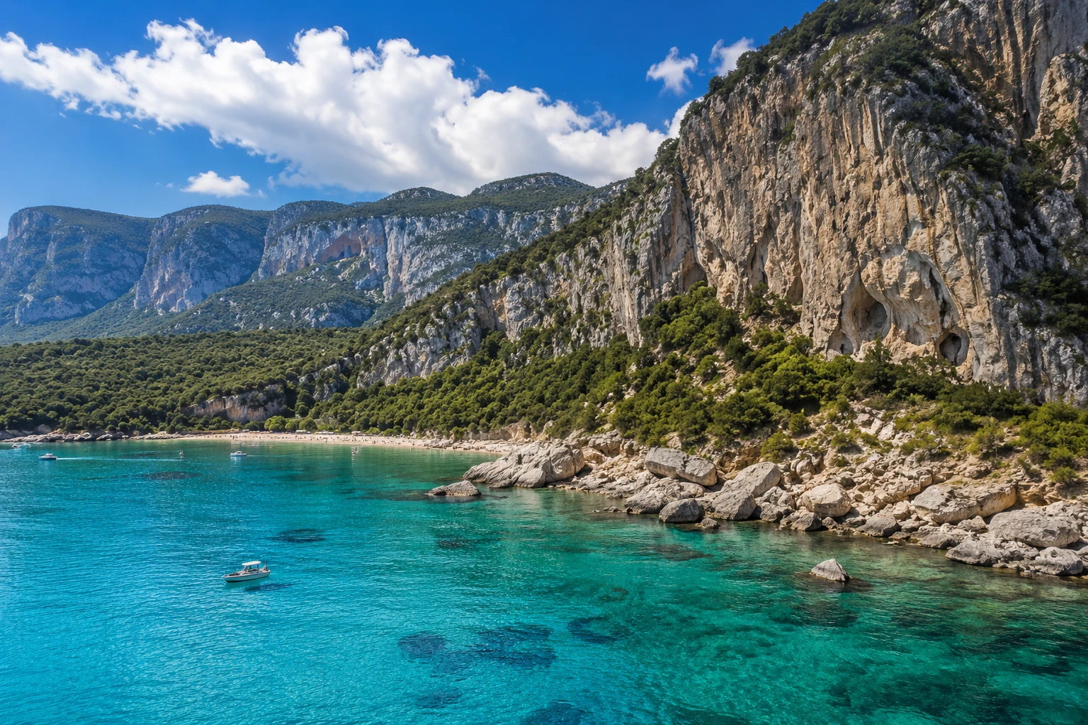 Gulf of Orosei with turquoise water, limestone cliffs, beaches, and small boats
